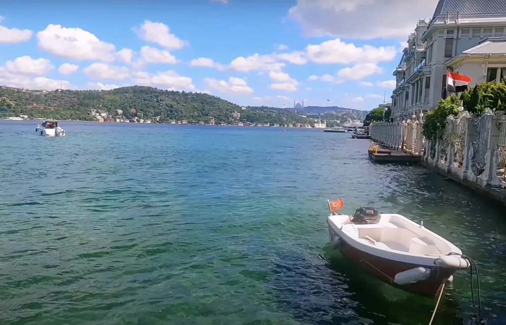 A view of Bebek Beach and waterline, with boats docked along the Bosphorus and a scenic waterfront.