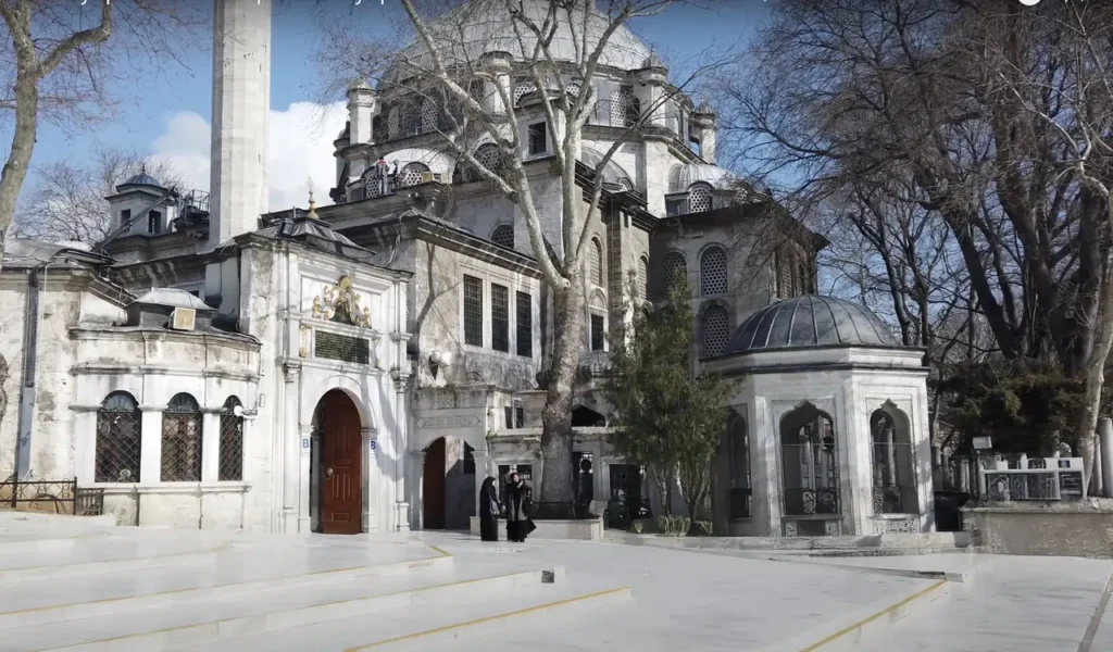 Eyüpsultan Mosque as seen from the square, with the surrounding courtyard and visitors.