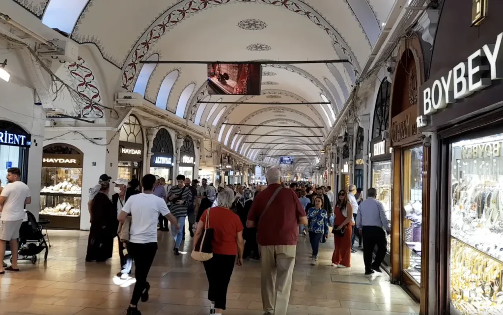 Hallway of the Grand Bazaar in Istanbul, lined with shops and colorful displays.