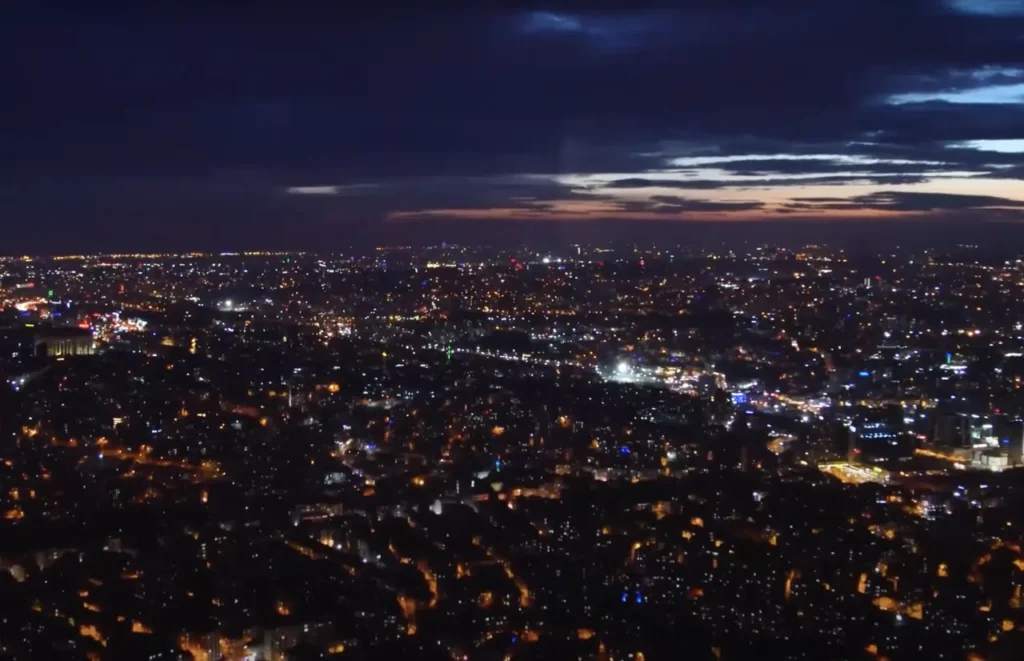 A nighttime aerial view of Istanbul from the Sapphire Tower, with city lights stretching to the horizon.