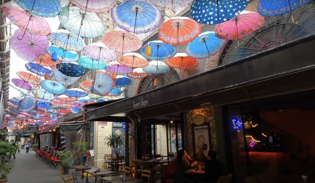 A street in Karaköy, Istanbul, adorned with colorful hanging umbrellas.