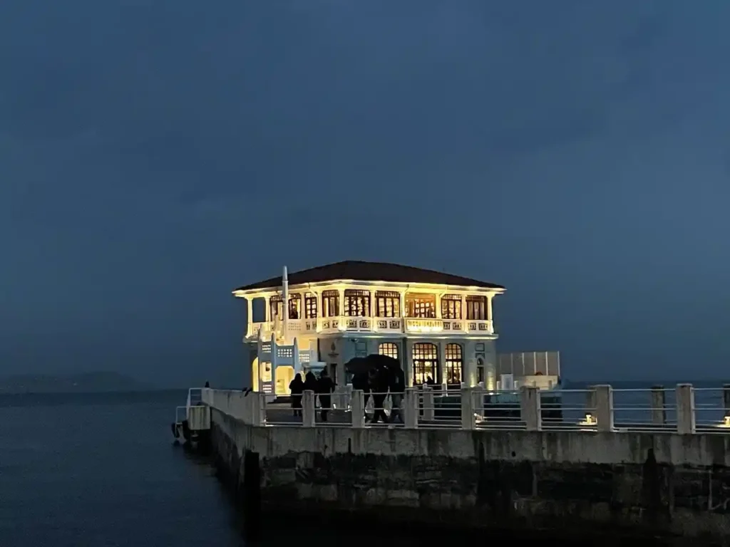 Nighttime image of Moda Pier in Istanbul, showcasing the pier illuminated against the night sky.