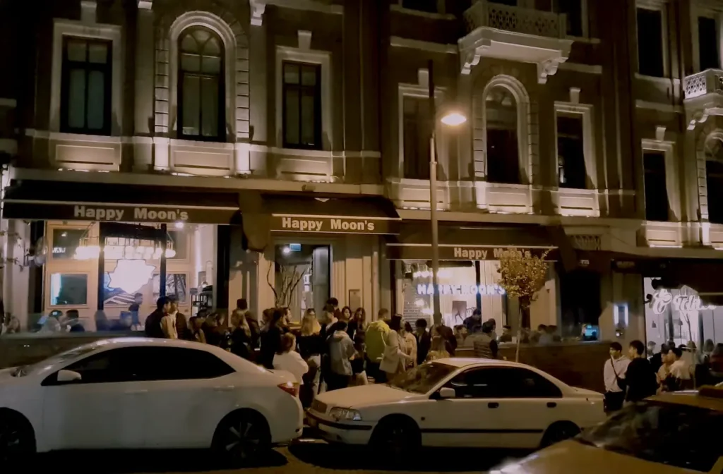 Sair Nedim Street illuminated at night, with stylish cafes and bars along the street.