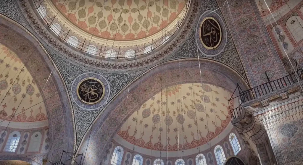Interior of Rüstem Pasha Mosque with intricate blue Iznik tiles and ornate Ottoman design.