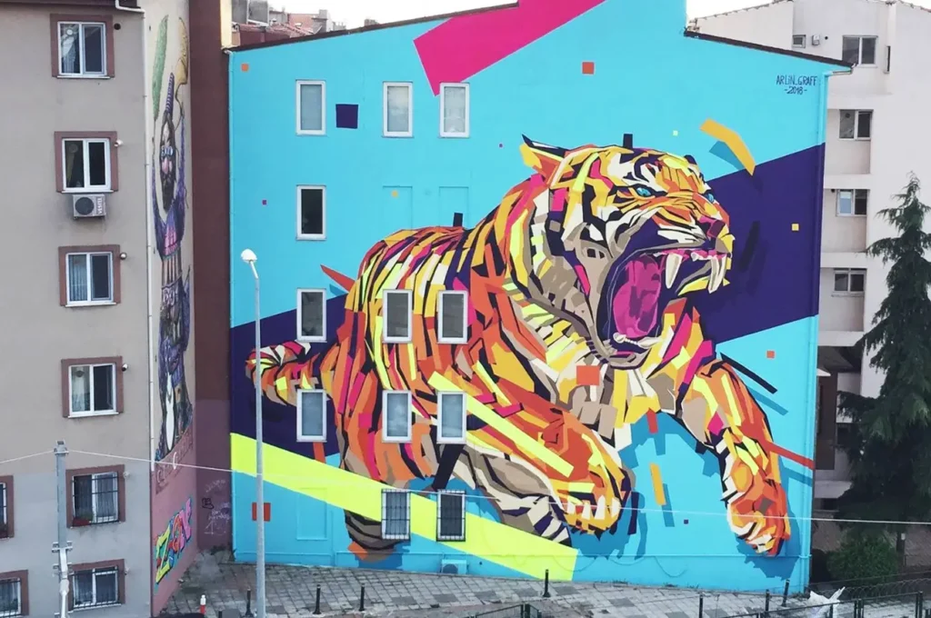A vibrant tiger mural painted on a wall in Istanbul, showcasing local street art.