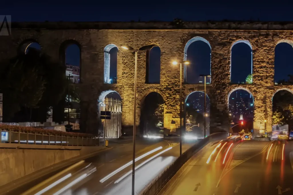 The Valens Aqueduct at night, with cars passing underneath, captured with a long exposure effect.