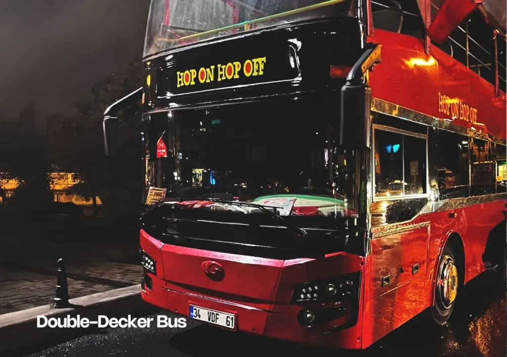 A red double-decker tourist bus driving through Istanbul, offering sightseeing tours.