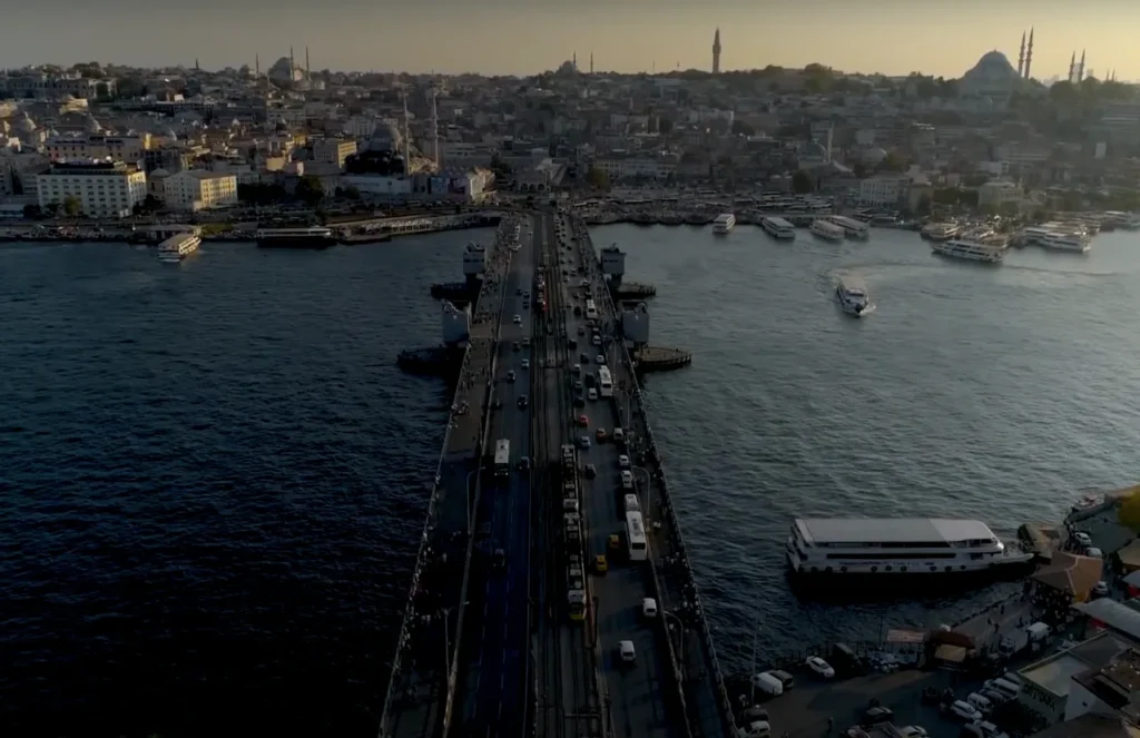 Aerial view of Galata Bridge, with traffic, fishermen, and boats on the Golden Horn.
