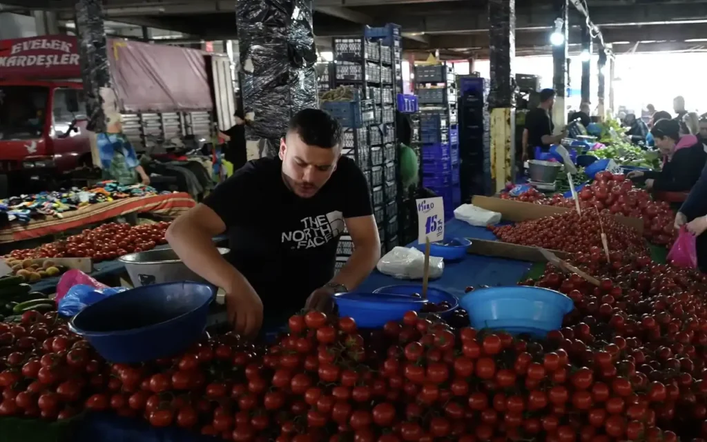 Saturday market in Beşiktaş, Istanbul, with vendors selling fresh produce, clothes, and local goods.