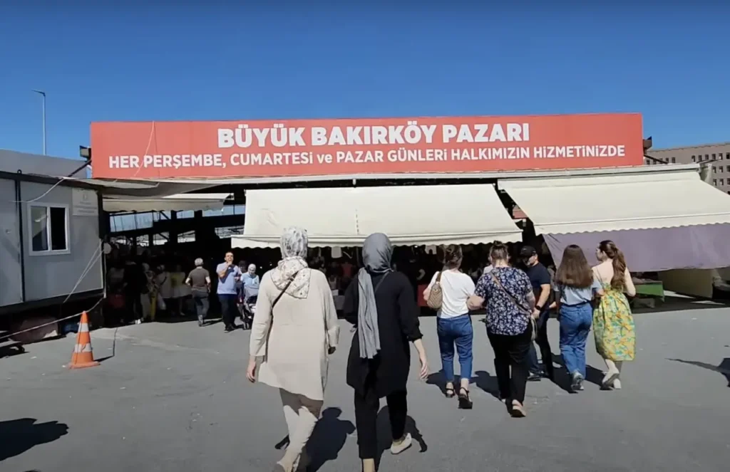 Entrance to Bakırköy Market, with shoppers entering the bustling market area.