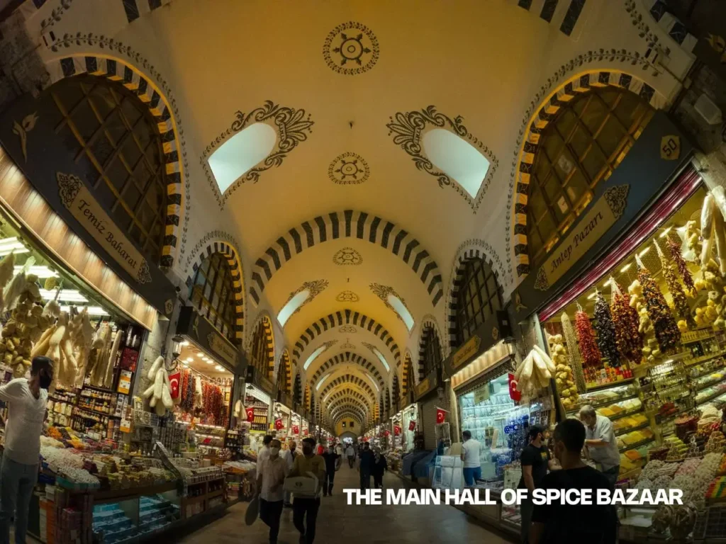 Main hall of the Spice Bazaar in Istanbul, featuring rows of shops selling spices, teas, and sweets.