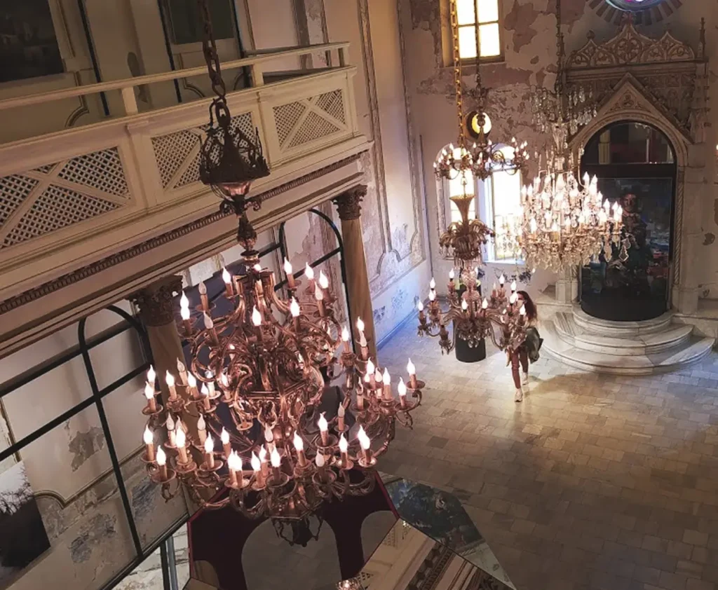 Chandeliers hanging inside Zülfaris Karaköy, a historic synagogue in Istanbul, featuring intricate designs.
