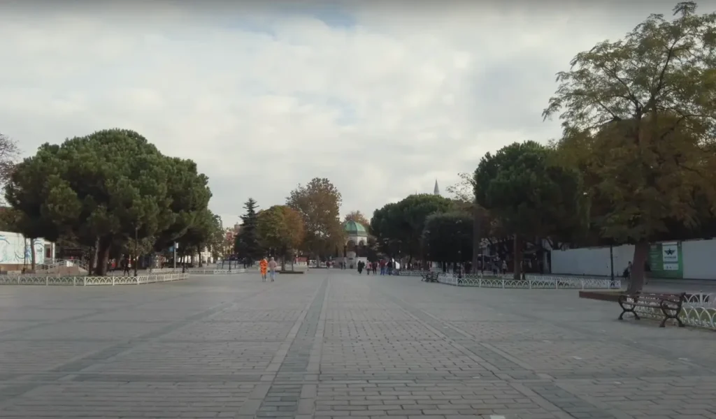 A view of Sultanahmet Square in Istanbul, with a fountain in the background and historic landmarks nearby.