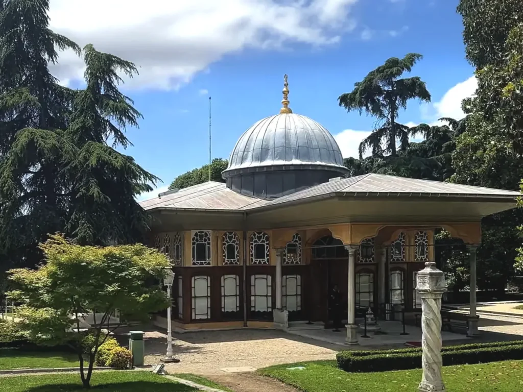 A view of Aynalıkavak Pavilion, surrounded by scenic gardens and trees.