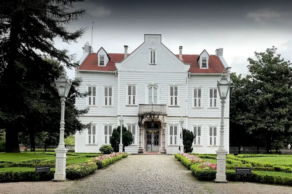 A view of Maslak Pavilion from the garden, surrounded by greenery.