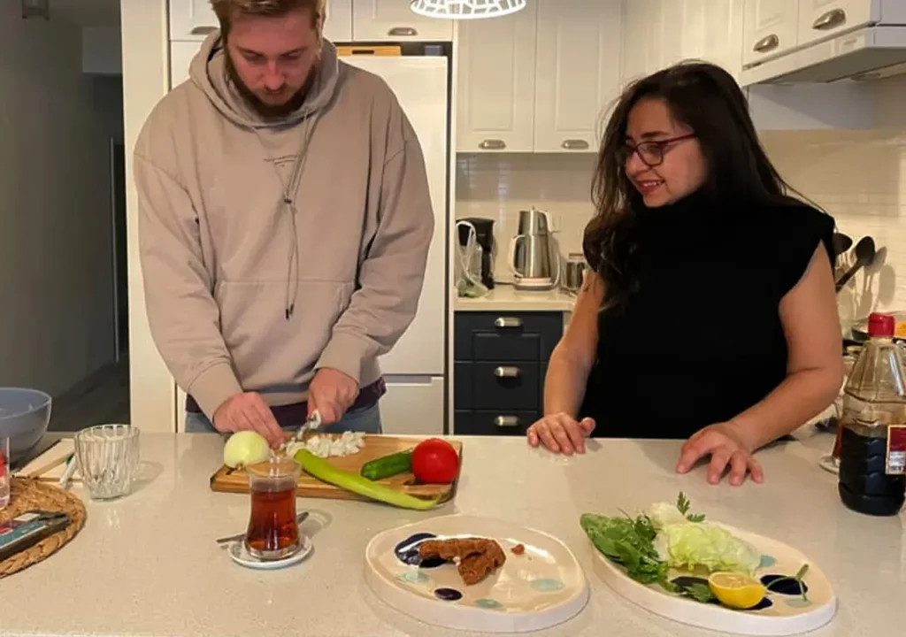 Guests and the Host preparing Turkish meze in a cooking master class.