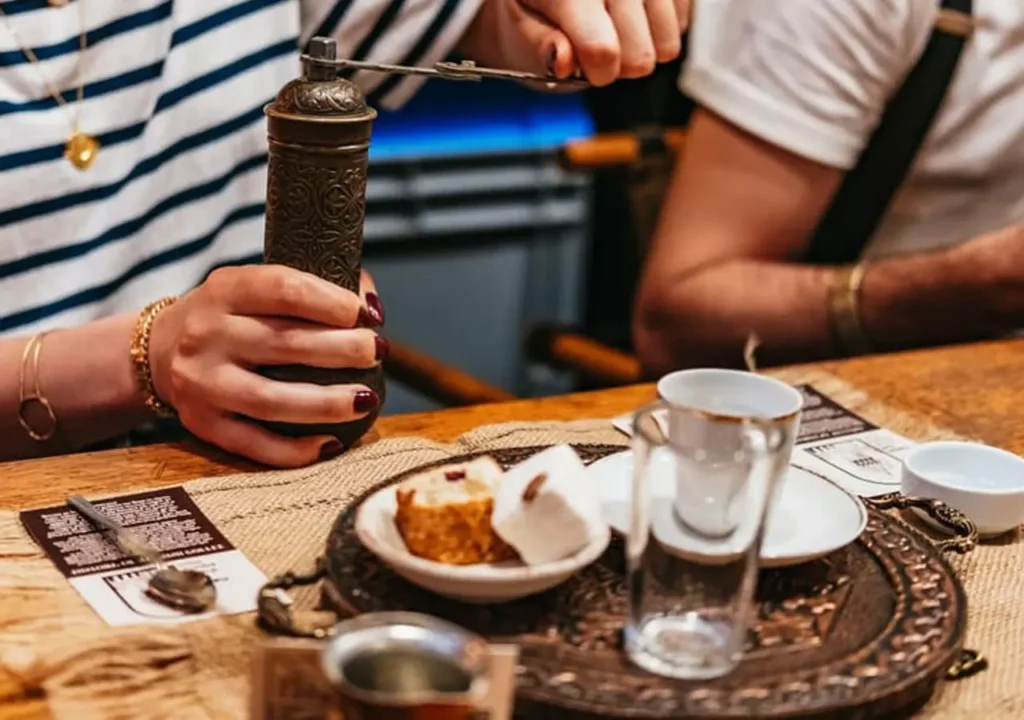 Grinding coffee beans by hand at a coffee workshop.