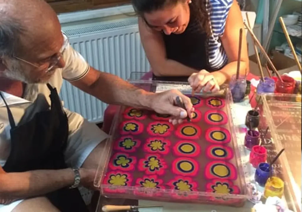 Creating marbled paper in an Ebru workshop.