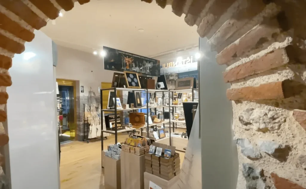 Souvenir shop inside Galata Tower with miniatures of the tower, postcards, and Turkish souvenirs.