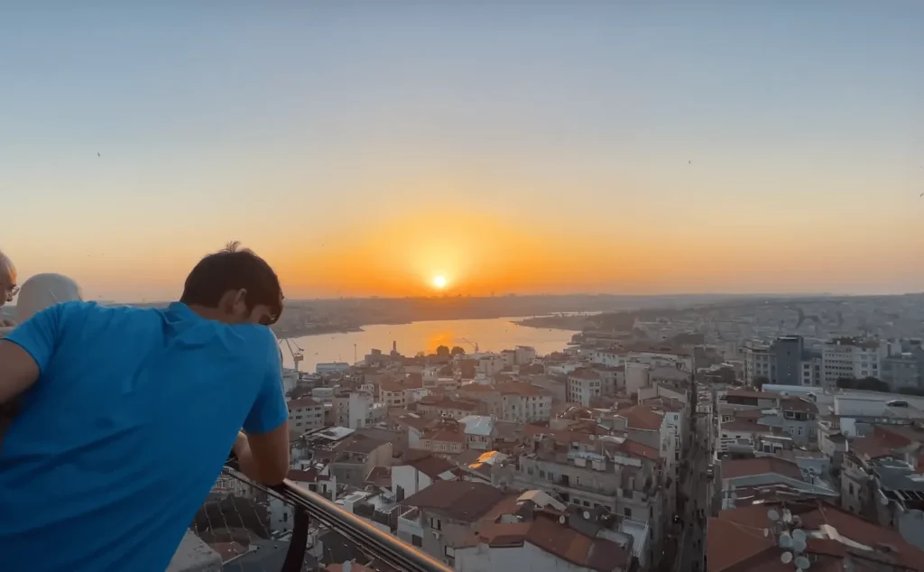 Evening view from the top of Galata Tower, with Istanbul’s sun and Bosphorus in the distance.