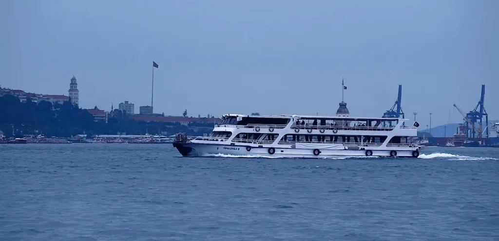 Ferry on the Bosphorus during the evening with cloudy sky.